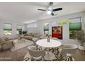 Bright living space with modern ceiling fan, dining set, comfortable seating, and natural light at 19982 N Tealstone Dr, Surprise, AZ 85374