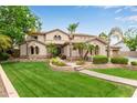 Expansive home with manicured front lawn, mature palms, and neutral color scheme at 2024 E Taurus Pl, Chandler, AZ 85249