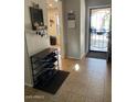 Open foyer with tile flooring, secure front door, and shoe storage at 22074 S 211Th St, Queen Creek, AZ 85142