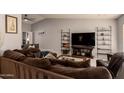 Spacious living room features a plush sofa, modern shelving, and a large flat-screen TV at 2324 E Cortez St, Phoenix, AZ 85028
