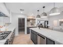 Spacious modern kitchen featuring gray cabinetry and a view of the living room at 2546 E Roma Ave, Phoenix, AZ 85016