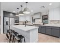Modern kitchen with an island, stainless steel appliances, and chic pendant lighting at 2546 E Roma Ave, Phoenix, AZ 85016