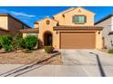 Inviting home featuring desert landscaping, covered entry, and an attached two-car garage at 25627 N 163Rd Dr, Surprise, AZ 85387