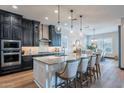 Modern kitchen showcases granite countertops, stainless steel appliances, and a large center island with bar seating at 26689 W Ponderosa Ln, Buckeye, AZ 85396
