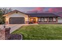 Charming single-story home featuring a well-manicured lawn, brick accents, and a two-car garage at 2726 E Hale St, Mesa, AZ 85213
