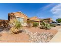 Attractive desert-landscaped front yard with native plants and rock features creating curb appeal at 29193 N Mountain View Rd, San Tan Valley, AZ 85143