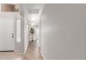 Inviting hallway with laminate wood floors, neutral paint, and ample natural light at 29193 N Mountain View Rd, San Tan Valley, AZ 85143
