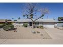 Well-maintained single-story home showcasing desert landscaping, updated stone accents, and a two-car garage at 3138 N 82Nd Pl, Scottsdale, AZ 85251