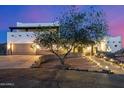Beautiful southwestern-style home with a desert landscape and illuminated walkway that accents the architecture at 3333 N 87Th St, Mesa, AZ 85207