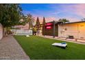 Spacious backyard featuring lush artificial turf, a pergola, and dedicated games area at 4020 N 34Th St, Phoenix, AZ 85018