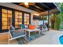 Inviting outdoor living space with comfortable seating, television, and an outdoor kitchen area at 4020 N 34Th St, Phoenix, AZ 85018