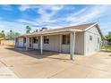 The back of the house features a concrete parking area and a covered patio at 4343 E Union Hills Dr, Phoenix, AZ 85050