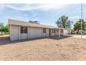 View of the back and side of the property shows low-maintenance landscaping and a covered patio at 4343 E Union Hills Dr, Phoenix, AZ 85050