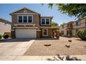 Tan two story home with a two car garage and a small front porch at 4349 E Windsor Ct, Gilbert, AZ 85296