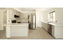 Bright kitchen with stainless steel appliances, island, and light wood floors at 4349 E Windsor Ct, Gilbert, AZ 85296