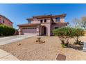 Front view of a two-story house with well-maintained desert landscaping at 4826 S 26Th Ln, Phoenix, AZ 85041