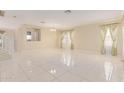 Spacious living area featuring tile floors and large windows at 4826 S 26Th Ln, Phoenix, AZ 85041