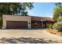 Charming single-story home featuring desert landscaping, a large driveway, and a two-car garage at 5616 E Desert Vista Trl, Cave Creek, AZ 85331