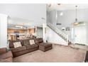 Spacious living room with high ceilings, stairway and seamless flow to the kitchen at 6528 S 258Th Dr, Buckeye, AZ 85326