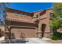 Attractive two-story house showing off the desert landscaping and a two-car garage at 6746 W Wethersfield Rd, Peoria, AZ 85381