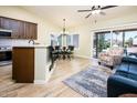 Open-concept living area with vaulted ceilings, wood-look floors, and backyard access at 6831 S Coral Gable Dr, Chandler, AZ 85249