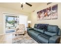 Comfortable living room featuring tile floors, a vaulted ceiling, and sliding glass doors at 6831 S Coral Gable Dr, Chandler, AZ 85249