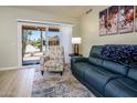 Cozy living room with comfortable seating and a view of the outdoors through sliding glass doors at 6831 S Coral Gable Dr, Chandler, AZ 85249