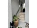 Charming entrance with stone steps and lush potted plants at 7272 E Gainey Ranch Rd # 121, Scottsdale, AZ 85258
