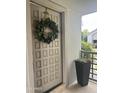Inviting front door with a decorative wreath and planter box at 7272 E Gainey Ranch Rd # 121, Scottsdale, AZ 85258