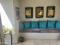 Cozy sitting area with decorative pillows, artwork and neutral tile flooring creating a warm, inviting space at 7272 E Gainey Ranch Rd # 121, Scottsdale, AZ 85258