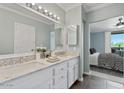 Elegant bathroom with double vanity, white cabinets, and a view to the bedroom at 7575 E Indian Bend Rd # 2002, Scottsdale, AZ 85250