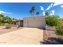 Single-story house showing the full front elevation with driveway and desert landscaping at 9629 N 83Rd Way, Scottsdale, AZ 85258