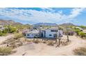 Sprawling desert home set among saguaro cactus with mountain views and a private drive at 3215 N 83Rd St, Mesa, AZ 85207
