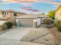 Attractive one-story home featuring a gray garage door, desert landscaping, and beautiful flowering bushes at 4446 E Chaparosa Way, Cave Creek, AZ 85331