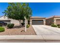 Attractive single-story home with desert landscaping and a two-car garage in a residential neighborhood at 4992 E Rhodium Dr, San Tan Valley, AZ 85143