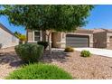 Attractive single-story home with desert landscaping and a two-car garage in a residential neighborhood at 4992 E Rhodium Dr, San Tan Valley, AZ 85143