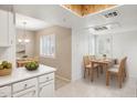 Bright dining area view featuring a skylight and plantation shutters for a light airy feel at 9736 N 95Th St # 225, Scottsdale, AZ 85258