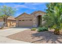 Charming single-story home featuring a well-maintained front yard with desert landscaping and a two-car garage at 15391 W Yucatan Dr, Surprise, AZ 85379