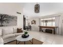 Comfortable living room with neutral tones, tile floors, and dining area at 30374 N Sunray Dr, Queen Creek, AZ 85143