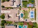 Expansive property featuring lush landscaping, pool, putting green, basketball courts, playground, and multiple outdoor entertainment areas at 3356 E Vallejo Ct, Gilbert, AZ 85298