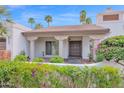 Inviting front entrance with stone accents, manicured landscaping and unique architectural features at 8337 E Shetland Trl, Scottsdale, AZ 85258