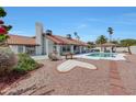 Expansive backyard featuring a pool, patio area, and desert landscaping perfect for outdoor entertaining at 13631 N 70Th Dr, Peoria, AZ 85381