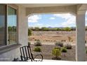 Inviting covered porch with seating area and views of natural surroundings at 27604 W Runion Dr, Buckeye, AZ 85396