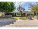Well-maintained single-story home showcasing lush landscaping, mature trees, and inviting curb appeal at 2938 N 18Th Ave, Phoenix, AZ 85015
