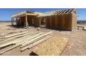 New home under construction, showing wooden framing and initial stages of exterior build at 1664 N 431St Ave, Tonopah, AZ 85354