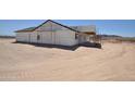 New construction shows exterior and covered patio with unfinished siding and framing, in a desert environment at 1664 N 431St Ave, Tonopah, AZ 85354
