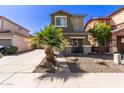 Inviting two-story home with desert landscaping, showcasing a tidy front yard and attractive curb appeal at 11979 W Pierce St, Avondale, AZ 85323