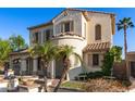 Two-story stucco home showcasing lush landscaping, a tile roof, and a gated driveway at 12911 W Campbell Ave, Litchfield Park, AZ 85340