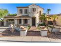 Beautiful stucco home featuring a covered gated drive and stone walkway leading to the front door at 12911 W Campbell Ave, Litchfield Park, AZ 85340