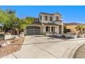 Stucco home with gated drive, tile roof, desert landscaping, and a curved entrance at 12911 W Campbell Ave, Litchfield Park, AZ 85340